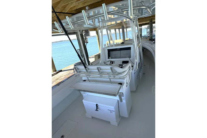 Slide: The Image of 2025 Contender 32 ST boat interior with helm station and fishing rod holders. - 21