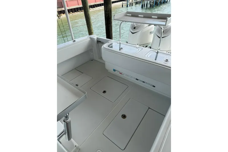Slide: The Image of 2025 Contender 32 ST boat deck with storage compartments and fishing station. - 25
