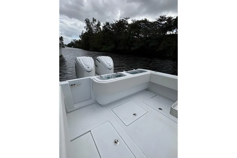 Slide: The Image of 2025 Contender 32 ST boat with dual engines on a calm river. - 3