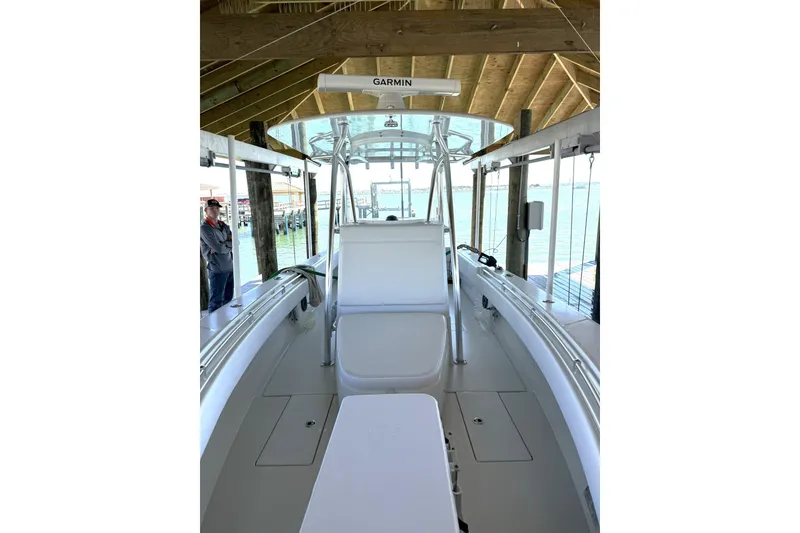 Slide: The Image of 2025 Contender 32 ST boat interior under a wooden dock with Garmin equipment. - 30