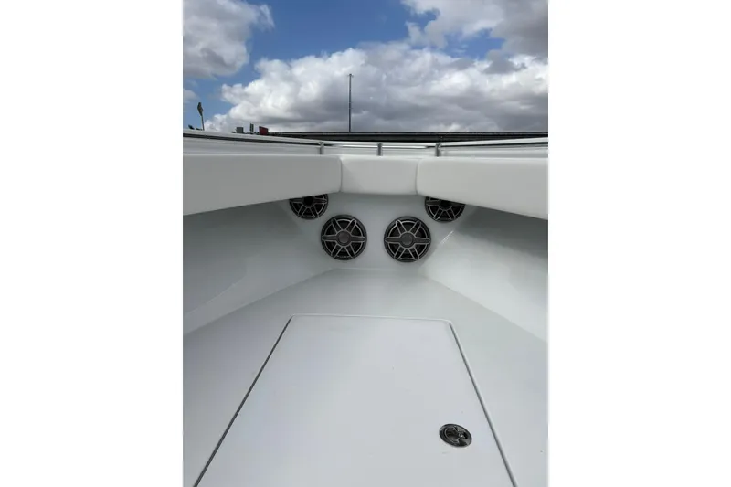 Slide: The Image of 2025 Contender 32 ST boat interior with speakers, under a cloudy sky. - 7