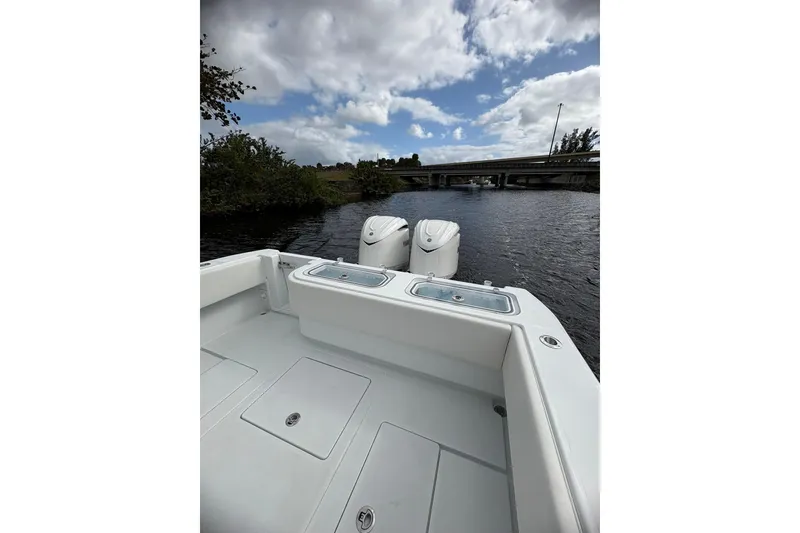 Slide: The Image of 2025 Contender 32 ST boat on water, featuring dual engines and spacious deck. - 8