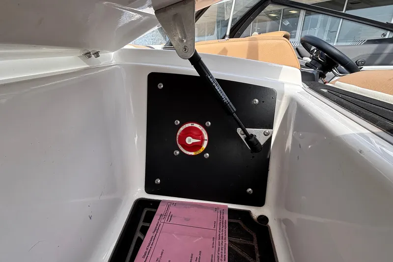 Slide: The Image of 2021 Tigé 25ZX boat interior with battery switch and hydraulic support. - 23
