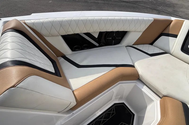 Slide: The Image of 2021 Tigé 25ZX boat interior with luxurious tan and white seating. - 30