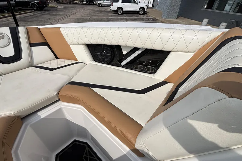 Slide: The Image of 2021 Tigé 25ZX boat interior with luxurious tan and white seating. - 32