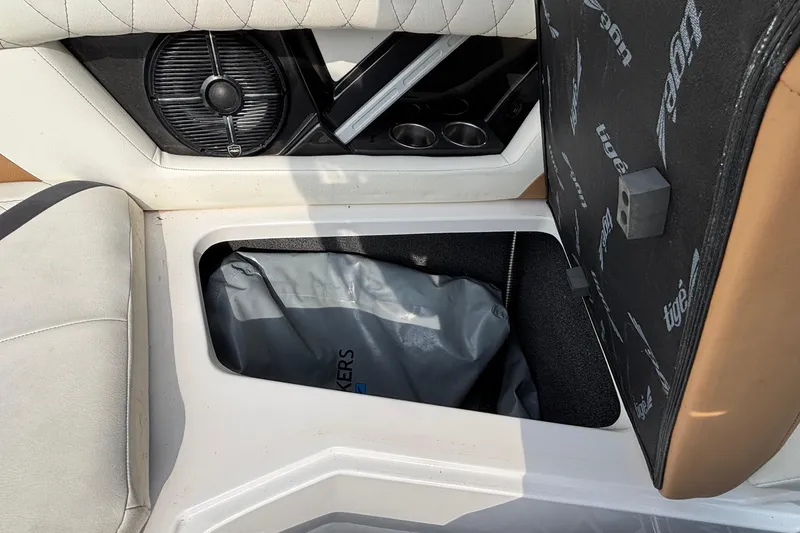 Slide: The Image of 2021 Tigé 25ZX boat interior storage compartment with speaker and cup holders. - 34