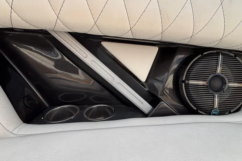 Slide: The Image of 2021 Tigé 25ZX boat interior with speaker, cup holders, and quilted upholstery. - 35