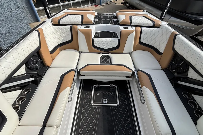 Slide: The Image of 2021 Tigé 25ZX boat interior with luxurious white and tan seating, cup holders, and speakers. - 40