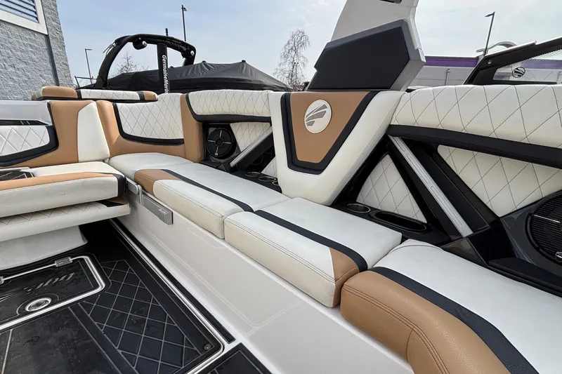 Slide: The Image of 2021 Tigé 25ZX boat interior with luxurious tan and white seating. - 43