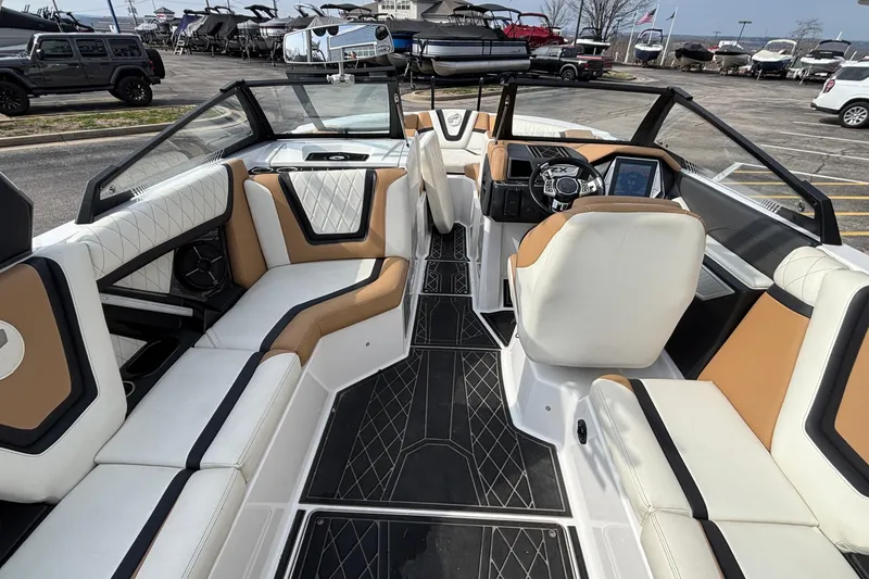 Slide: The Image of 2021 Tigé 25ZX boat interior with luxurious seating and modern dashboard. - 44