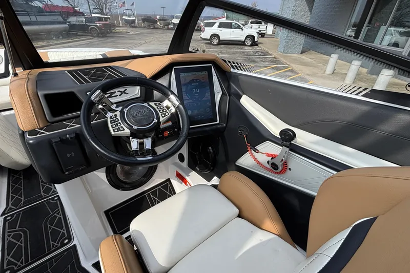 Slide: The Image of 2021 Tigé 25ZX boat interior with modern dashboard and steering wheel. - 47