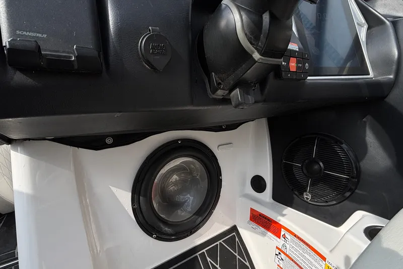Slide: The Image of Interior of 2021 Tigé 25ZX boat showing audio system and dashboard controls. - 49