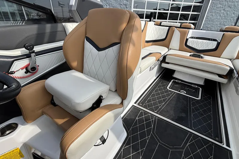 Slide: The Image of 2021 Tigé 25ZX boat interior with tan and white seating, modern design. - 50