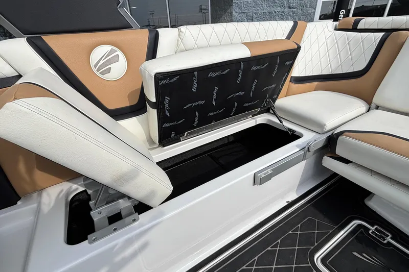 Slide: The Image of 2021 Tigé 25ZX boat interior with open storage compartment and stylish seating. - 52