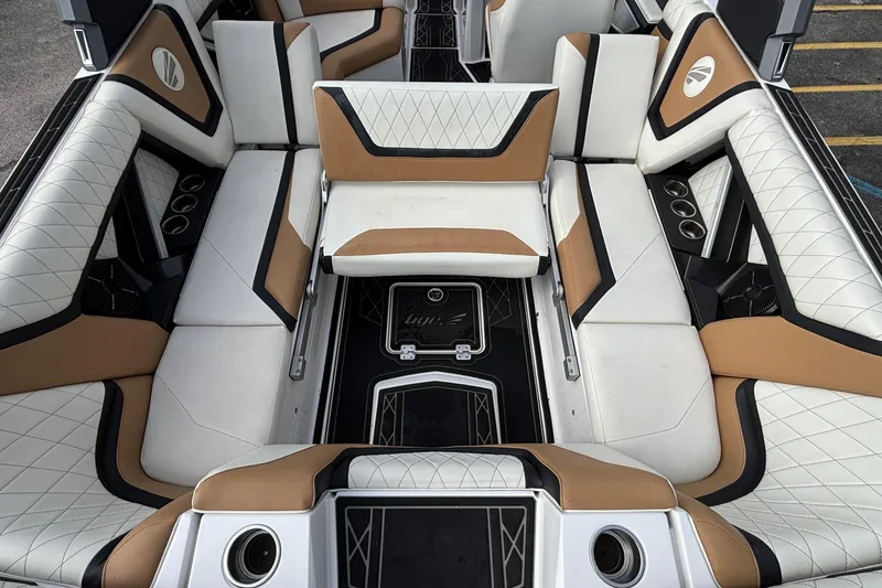 Slide: The Image of 2021 Tigé 25ZX boat interior with luxurious white and tan seating, cup holders, and stylish design. - 7
