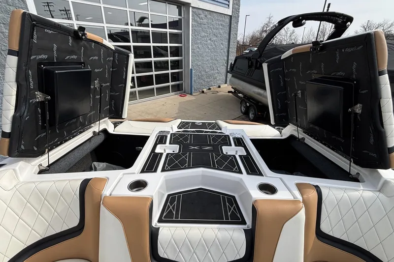 Slide: The Image of 2021 Tigé 25ZX boat interior with open storage compartments and stylish upholstery. - 8