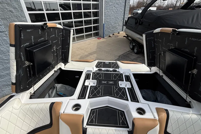 Slide: The Image of 2021 Tigé 25ZX boat interior with open storage compartments and stylish seating. - 9