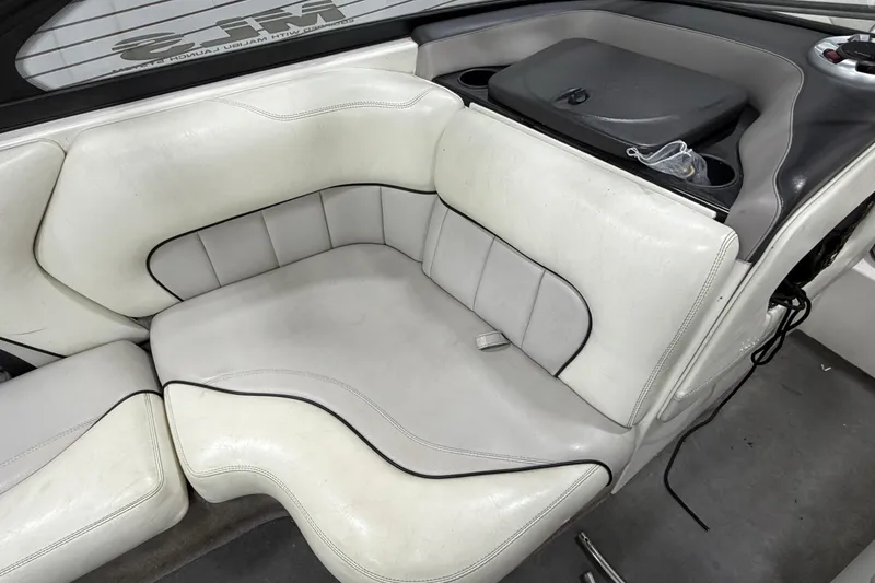 Slide: The Image of 2004 Malibu Wakesetter 23 LSV interior with white leather seating and cup holders. - 11