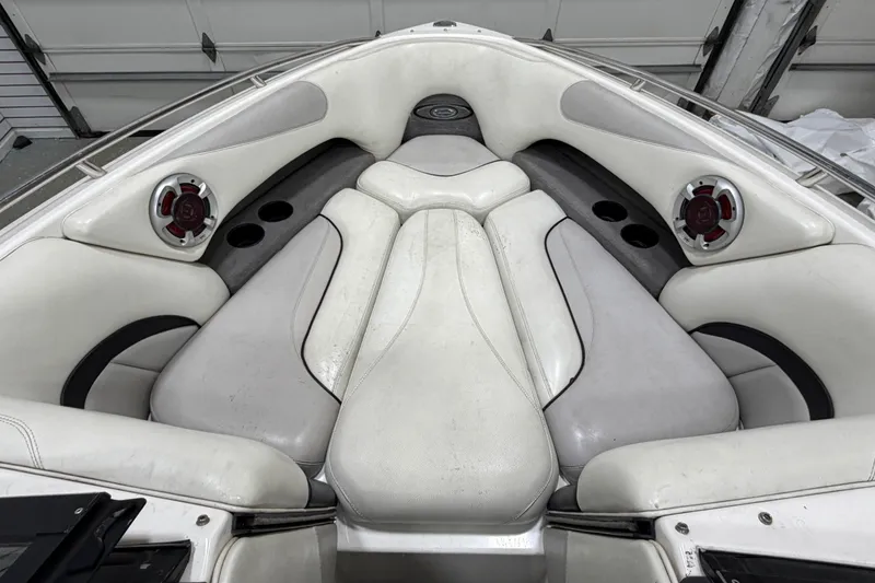 Slide: The Image of 2004 Malibu Wakesetter 23 LSV boat interior with white seating and speakers. - 12