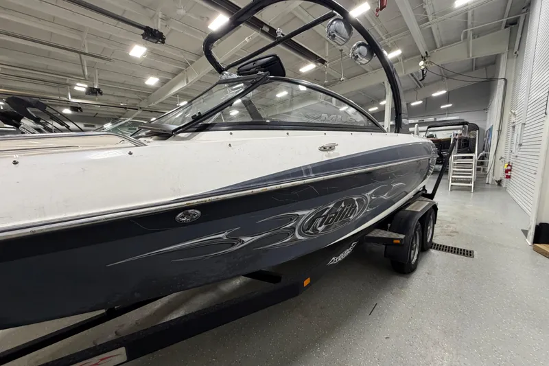 Slide: The Image of 2004 Malibu Wakesetter 23 LSV boat on trailer in indoor showroom. - 4
