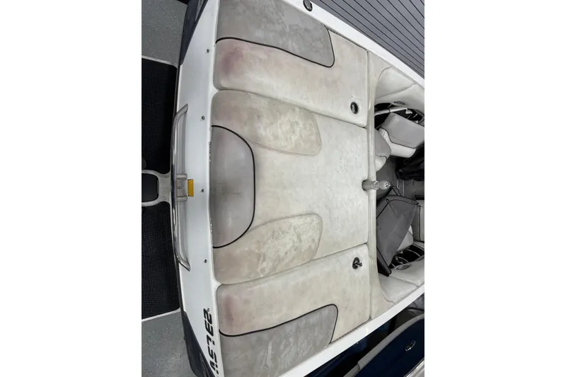 Slide: The Image of 2004 Malibu Wakesetter 23 LSV boat interior with white upholstery and seating area. - 6
