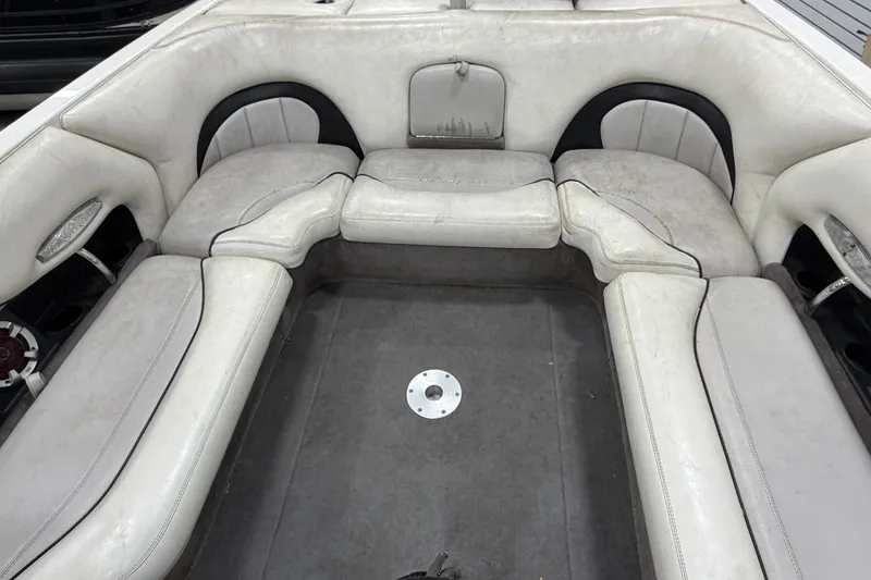 Slide: The Image of 2004 Malibu Wakesetter 23 LSV interior with white cushioned seating and gray flooring. - 7