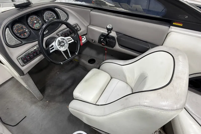 Slide: The Image of 2004 Malibu Wakesetter 23 LSV boat interior with steering wheel and dashboard controls. - 8