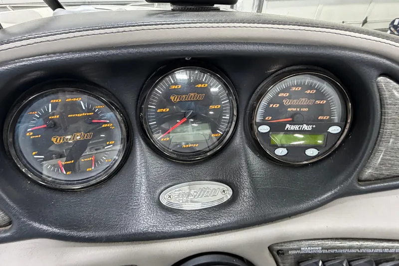 Slide: The Image of Dashboard of a 2004 Malibu Wakesetter 23 LSV with gauges and controls. - 9