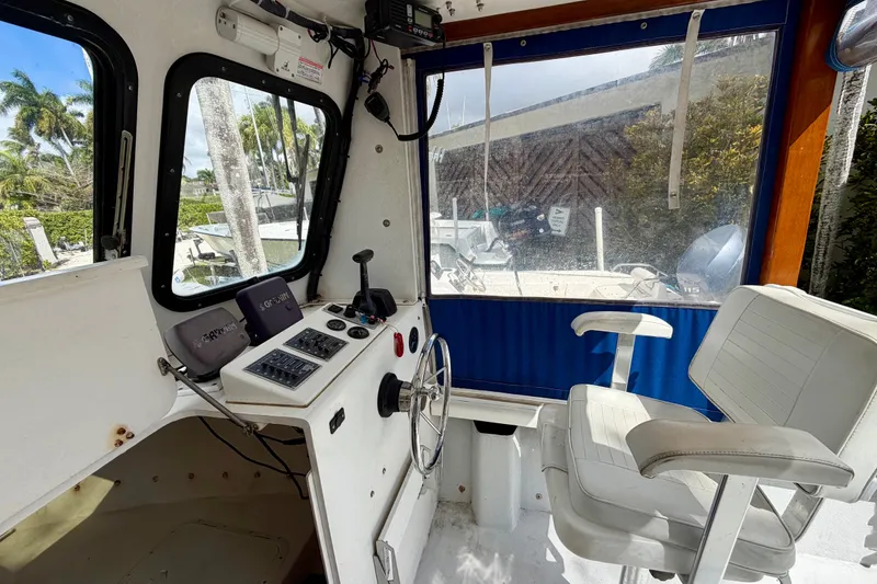 Slide: The Image of Interior of a 2000 Eastern 22 Lobster Fisherman boat with steering wheel and seating. - 10