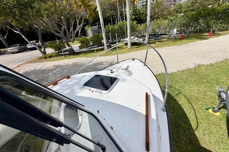 Slide: The Image of 2000 Eastern 22 Lobster Fisherman boat on grassy area, surrounded by trees and parked cars. - 12