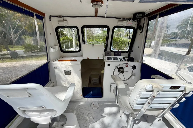 Slide: The Image of Interior of 2000 Eastern 22 Lobster Fisherman boat with steering wheel and seating. - 13