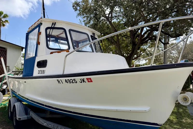 Slide: The Image of 2000 Eastern 22 Lobster Fisherman boat on trailer, white hull, blue cabin, outdoors. - 3