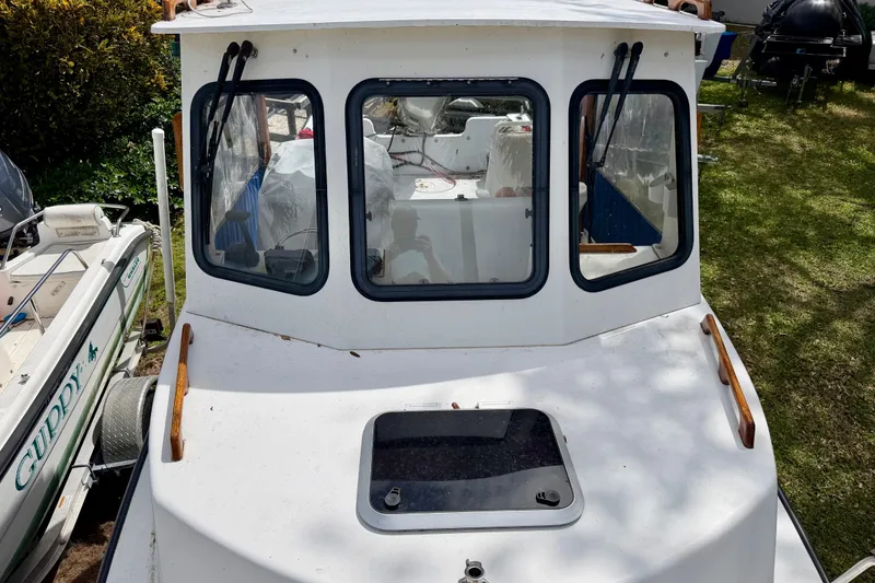 Slide: The Image of 2000 Eastern 22 Lobster Fisherman boat with cabin, docked on grass. - 6