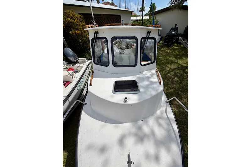 Slide: The Image of 2000 Eastern 22 Lobster Fisherman boat, white exterior, docked on grass. - 7