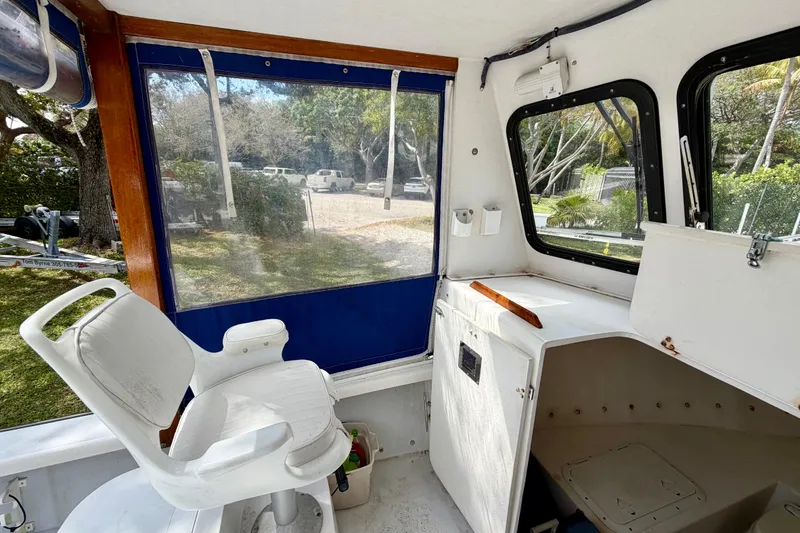 Slide: The Image of Interior of a 2000 Eastern 22 Lobster Fisherman boat with white seating and windows. - 8
