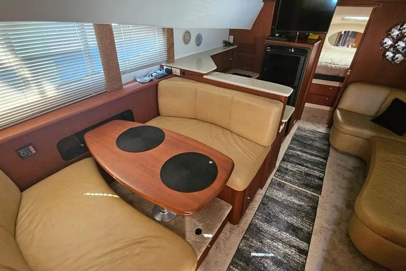 Slide: The Image of Interior of 2005 Silverton 330 Sport Bridge yacht with cozy seating and modern amenities. - 13