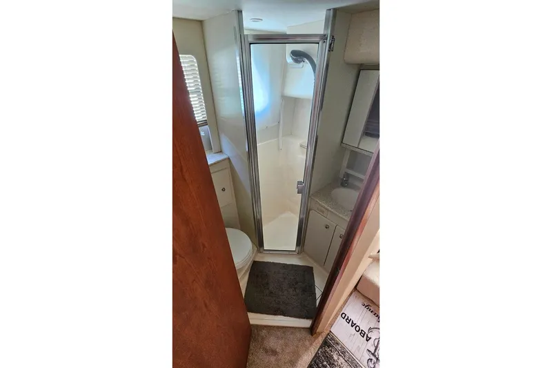 Slide: The Image of 2005 Silverton 330 Sport Bridge bathroom with shower, sink, and toilet. - 15