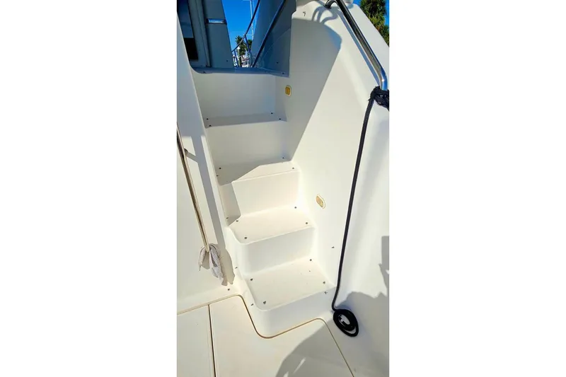Slide: The Image of Staircase on 2005 Silverton 330 Sport Bridge yacht, featuring sleek white design. - 17