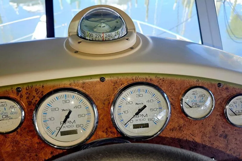 Slide: The Image of Dashboard of a 2005 Silverton 330 Sport Bridge with compass and gauges. - 21
