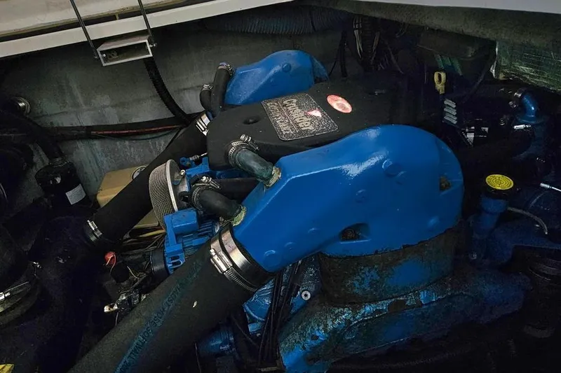 Slide: The Image of Engine compartment of a 2005 Silverton 330 Sport Bridge with blue components. - 26