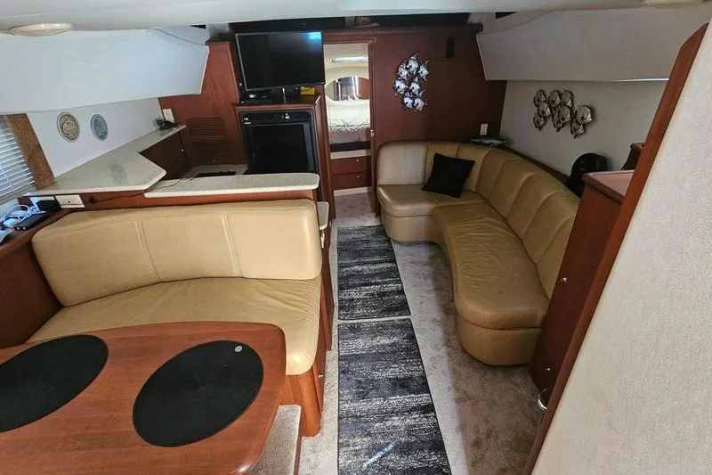 Slide: The Image of Interior of 2005 Silverton 330 Sport Bridge yacht with cozy seating and modern amenities. - 4