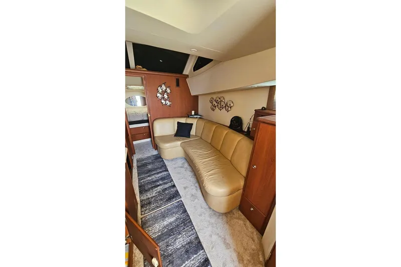 Slide: The Image of Interior of 2005 Silverton 330 Sport Bridge with beige leather seating and modern decor. - 5