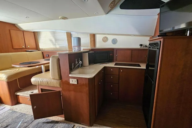 Slide: The Image of Interior of 2005 Silverton 330 Sport Bridge yacht with kitchen and dining area. - 7