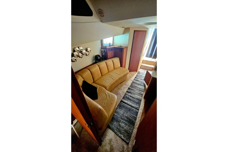 Slide: The Image of Interior of 2005 Silverton 330 Sport Bridge with beige seating and modern decor. - 9