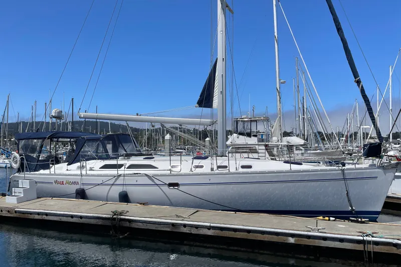 The Image of 2005 Catalina 470 sailboat docked at marina under clear blue sky. - 0