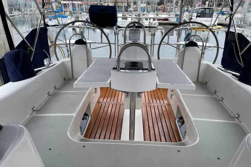 Slide: The Image of Cockpit of 2005 Catalina 470 sailboat with dual steering wheels and wooden flooring. - 10