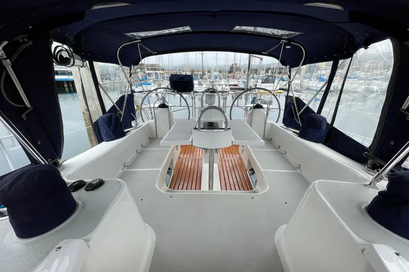 Slide: The Image of Interior view of a 2005 Catalina 470 sailboat cockpit with marina background. - 11