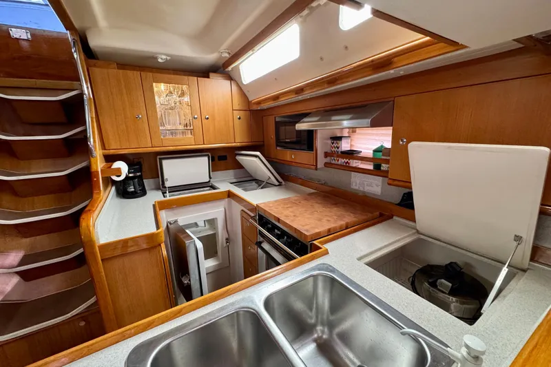 Slide: The Image of Luxurious 2005 Catalina 470 yacht kitchen with wood cabinetry and modern appliances. - 15