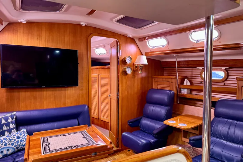 Slide: The Image of Interior of 2005 Catalina 470 yacht with luxurious seating and wooden finishes. - 17