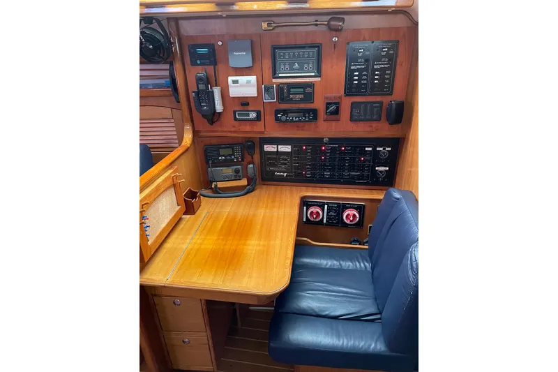 Slide: The Image of Navigation station of a 2005 Catalina 470 yacht with control panels and seating. - 19